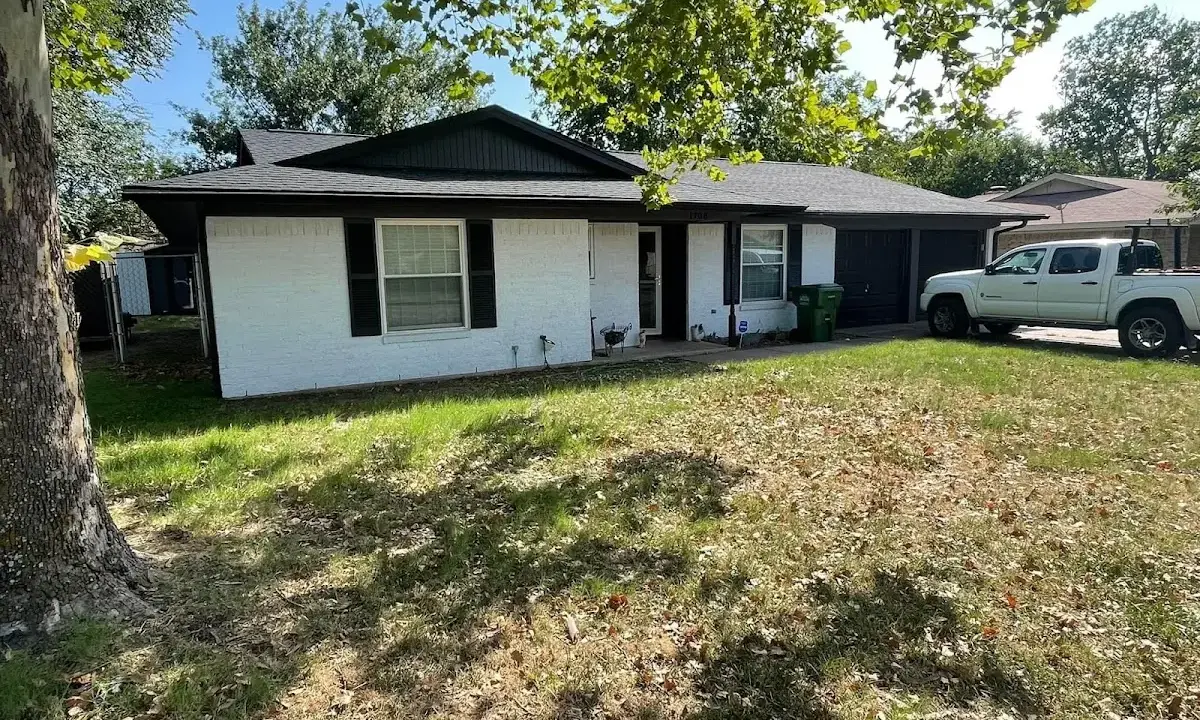 Professional roofing crew working on a residential roof in Crookston